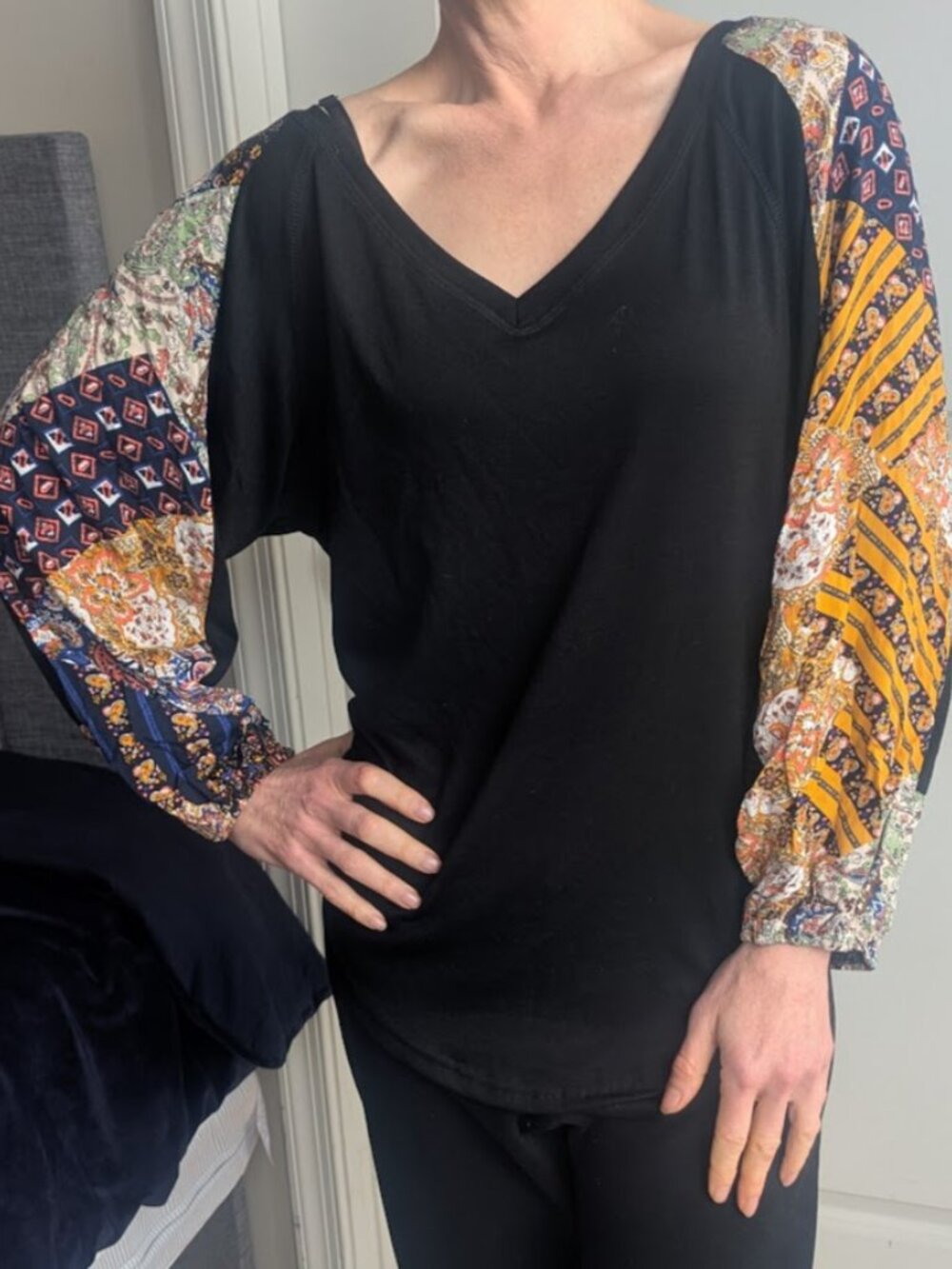 Boho black top with colorful patchwork sleeves. NWT.